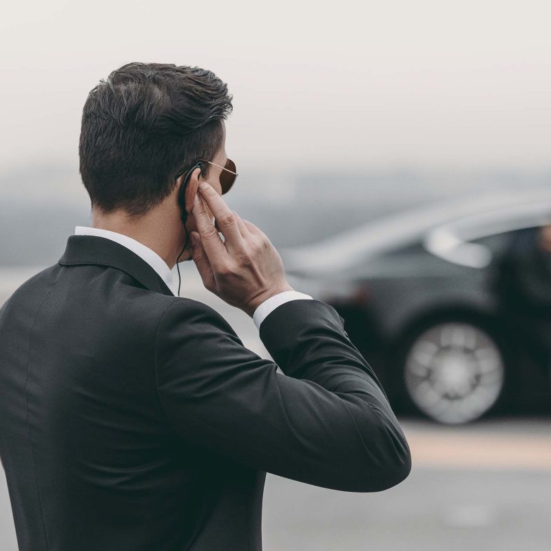 handsome-bodyguard-standing-and-listening-message-A78BNHN.jpg